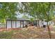 Back of a bright home featuring a door, deck and new air conditioner at 18015 Beach St, Umatilla, FL 32784