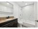 This renovated bathroom offers a modern vanity, tub, and shower with sleek, white-tiled walls at 18015 Beach St, Umatilla, FL 32784
