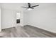 Bright bedroom features updated gray flooring, fresh white paint, and a modern ceiling fan with light at 18015 Beach St, Umatilla, FL 32784