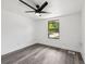 This light and airy bedroom has a modern ceiling fan and sleek, gray laminate flooring at 18015 Beach St, Umatilla, FL 32784