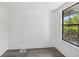 Bedroom with window and updated gray flooring at 18015 Beach St, Umatilla, FL 32784