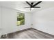 This light and airy bedroom has a modern ceiling fan and sleek, gray laminate flooring at 18015 Beach St, Umatilla, FL 32784