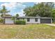 A well-maintained single-story home with a manicured lawn, mature landscaping, and an attached garage at 18015 Beach St, Umatilla, FL 32784