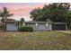 Charming single-Gathering home with well-manicured lawn and a two-car garage at 18015 Beach St, Umatilla, FL 32784