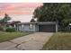 Charming single-story home featuring a two-car garage and a well-manicured lawn and landscape at 18015 Beach St, Umatilla, FL 32784
