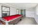 Bright game room showcasing a pool table, views of the backyard, and access to other areas at 18015 Beach St, Umatilla, FL 32784