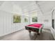 Spacious game room features a pool table, bright windows, and modern gray vinyl flooring at 18015 Beach St, Umatilla, FL 32784