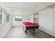 Well lit game room with pool table and many windows at 18015 Beach St, Umatilla, FL 32784