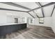 Stylish kitchen with a breakfast bar, modern lighting, and gray wood-look flooring at 18015 Beach St, Umatilla, FL 32784