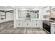 Beautiful kitchen with white cabinets, marble countertops, stainless steel appliances, and gray wood-look flooring at 18015 Beach St, Umatilla, FL 32784