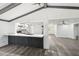 Bright living area showcasing a kitchen breakfast bar with gray wood-look floors and a vaulted ceiling at 18015 Beach St, Umatilla, FL 32784