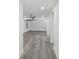 Open living space with gray wood-look floors, recessed lighting, and seamless flow at 18015 Beach St, Umatilla, FL 32784