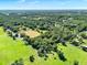 Aerial view highlighting the vast landscape with rolling pastures and lush woodlands at 187 N Samsula Dr, New Smyrna Beach, FL 32168