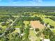 Expansive aerial view of land with lush green fields, scattered trees, and clear blue skies in the countryside at 187 N Samsula Dr, New Smyrna Beach, FL 32168