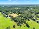 An aerial view of the property amongst lush Florida woodlands at 187 N Samsula Dr, New Smyrna Beach, FL 32168