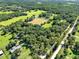 Expansive aerial view showing land with fields and trees in a rural community at 187 N Samsula Dr, New Smyrna Beach, FL 32168