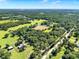 Sweeping aerial view of a rural landscape featuring fields, trees, and scattered homes with blue sky at 187 N Samsula Dr, New Smyrna Beach, FL 32168
