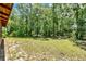 Expansive backyard featuring a lush lawn and mature trees creating a private and serene environment at 187 N Samsula Dr, New Smyrna Beach, FL 32168