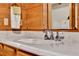 Close up of wood bathroom vanity featuring bright white countertop and faucet at 187 N Samsula Dr, New Smyrna Beach, FL 32168