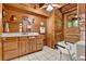 Bathroom with wood walls and ceiling, featuring a shower/tub combo and wood vanity at 187 N Samsula Dr, New Smyrna Beach, FL 32168