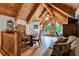 Lofted bedroom with cozy seating area and views of the outdoors through triangular windows at 187 N Samsula Dr, New Smyrna Beach, FL 32168