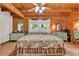Bedroom with wood walls and ceiling, featuring a bed with floral comforter and green dressers at 187 N Samsula Dr, New Smyrna Beach, FL 32168