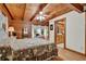 Bedroom with wood walls, ceiling, and view to the bathroom, with a floral comforter on the bed at 187 N Samsula Dr, New Smyrna Beach, FL 32168