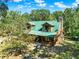 A view of the log cabin style home exterior featuring a stone chimney at 187 N Samsula Dr, New Smyrna Beach, FL 32168