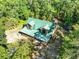 A view of the charming log cabin style home featuring a green roof at 187 N Samsula Dr, New Smyrna Beach, FL 32168