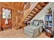 Inviting living area with wooden staircase, comfortable seating, and a rustic entryway at 187 N Samsula Dr, New Smyrna Beach, FL 32168