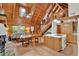 Open concept living area with wood beams, vaulted ceilings, and seamless flow to the kitchen at 187 N Samsula Dr, New Smyrna Beach, FL 32168