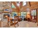 Cozy living room featuring a stone fireplace, wood-paneled walls, and comfortable furniture at 187 N Samsula Dr, New Smyrna Beach, FL 32168