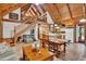 Spacious living area with vaulted ceilings, exposed beams, and staircase leading to the loft at 187 N Samsula Dr, New Smyrna Beach, FL 32168