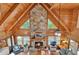Aerial view of the living room highlighting the stone fireplace and vaulted ceiling at 187 N Samsula Dr, New Smyrna Beach, FL 32168