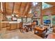 Open-concept living area boasts a stone fireplace, wood accents, and natural light at 187 N Samsula Dr, New Smyrna Beach, FL 32168