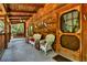 Charming log home porch with wooden accents, wicker chairs, and decorative details at 187 N Samsula Dr, New Smyrna Beach, FL 32168