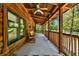 Inviting outdoor porch with stained wood beams, seating, and views of the surrounding landscape at 187 N Samsula Dr, New Smyrna Beach, FL 32168