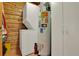 Functional utility room featuring a washer, dryer, water heater, and storage cabinets at 187 N Samsula Dr, New Smyrna Beach, FL 32168