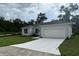 Charming single-story home with a gray roof and a freshly-poured white driveway at 1889 15Th St, Orange City, FL 32763