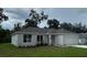 Charming single-story home with a gray roof and a well-manicured lawn at 1889 15Th St, Orange City, FL 32763