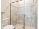 Bathroom shower with stone tile floor, and glass doors at 1889 15Th St, Orange City, FL 32763