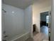 Bathroom with white tile walls and tub at 199 Afton Sq # 108, Altamonte Springs, FL 32714