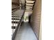 Hallway leading to stairwell with neutral walls and flooring, providing a glimpse of the outdoor landscape at 199 Afton Sq # 108, Altamonte Springs, FL 32714