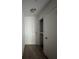 Hallway with white door, light fixture, and a closet, leading to other rooms with wooden floors at 199 Afton Sq # 108, Altamonte Springs, FL 32714