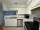 Bright kitchen with stainless steel appliances and white cabinets at 199 Afton Sq # 108, Altamonte Springs, FL 32714