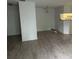 Open living area with wood-look flooring and plenty of space, offering a view into the kitchen at 199 Afton Sq # 108, Altamonte Springs, FL 32714