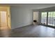 Spacious living area with wood-look floors, access to the bath, and a glass door for natural light at 199 Afton Sq # 108, Altamonte Springs, FL 32714