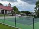 Community tennis court enclosed by fencing and overlooking the community center and pool at 199 Afton Sq # 108, Altamonte Springs, FL 32714