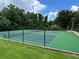 Community tennis court with a well-maintained green surface and black chain-link fence at 199 Afton Sq # 108, Altamonte Springs, FL 32714