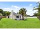 A large well-manicured backyard with a decorative palm tree and paved patio at 2089 Sunderland Rd, Maitland, FL 32751
